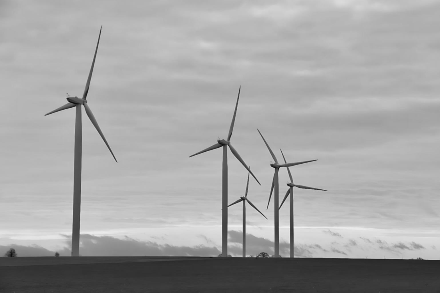 Moderne Windkraftanlagen bei Sonnenuntergang mit technischen Detailansichten